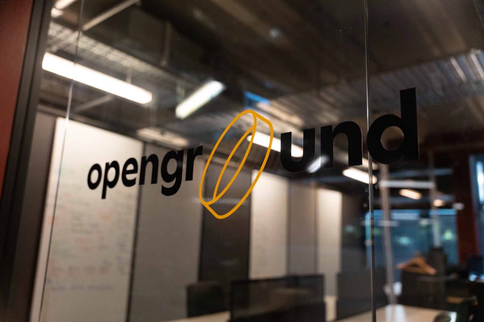The Openground logo on the glass of the programme space inside the B:HIVE