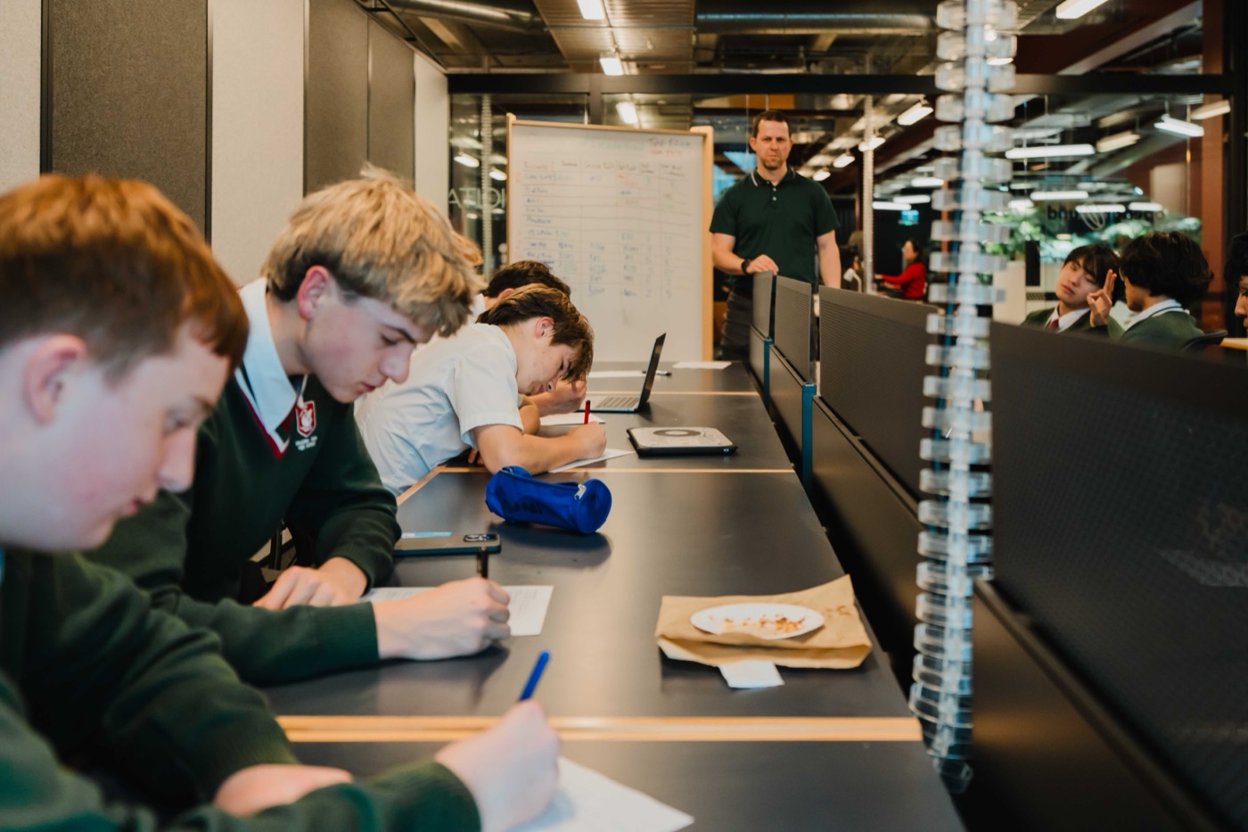 Students working through a session while the term's numbers go up on the whiteboard